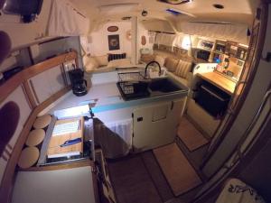 an overhead view of an rv kitchen with a sink at Voilier traditionnel, tout confort et au calme in Gruissan