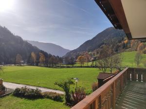 a balcony with a view of a field and mountains at Amadee Appartements in Bad Kleinkirchheim