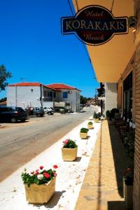 a street with potted plants on the side of a building at Hotel Korakakis Beach in Finikounta