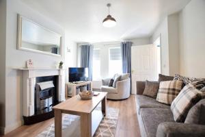 a living room with a couch and a fireplace at Portmore Holiday Home in Portrush