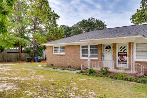 a brick house with a porch and a yard at Charming West Columbia Getaway - Near Downtown! in West Columbia
