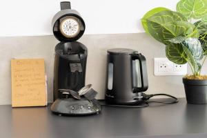 a coffee maker and a clock on a counter at Nouveau - Le Privacy - Europa Park in Sand