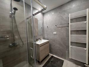 a bathroom with a glass shower and a sink at Zaros Cottage in Zarós