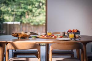 a wooden table with a plate of food on it at Holiday House BALE, BALE in Kostel