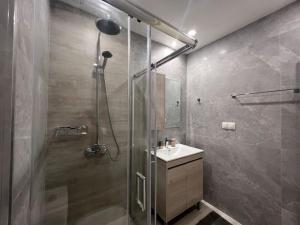 a bathroom with a shower and a sink at Zaros Cottage in Zaros