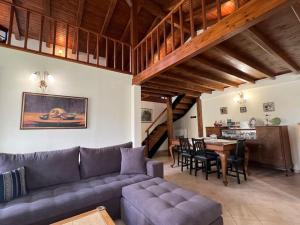 a living room with a couch and a table at Zaros Cottage in Zaros