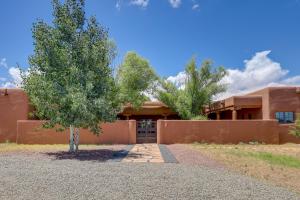 a house with a tree in front of it at Spacious Santa Fe Vacation Rental about 5 Mi to Town! in Santa Fe