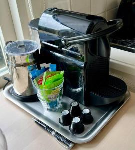 a coffee maker sitting on a tray on a counter at Seaside Tiny House only 300 meters from the beach in Noordwijk