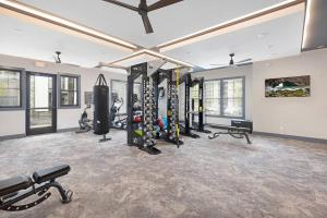 a gym with a bunch of equipment in a room at Modern Stylish Concord Condo in Concord