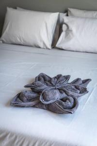 a pile of towels sitting on top of a bed at Oasis Penthouse Luxury Suite by Solea in Sliema