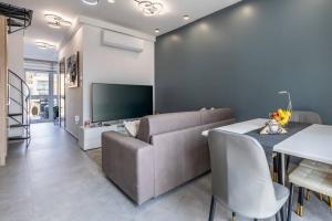 a living room with a couch and a table at Oasis Penthouse Luxury Suite by Solea in Sliema