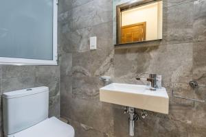 a bathroom with a white toilet and a sink at Oasis Penthouse Luxury Suite by Solea in Sliema +14 photos