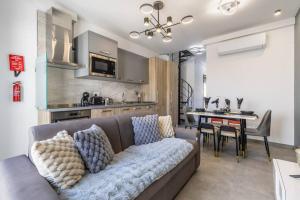 a living room with a couch and a dining room at Oasis Penthouse Luxury Suite by Solea in Sliema