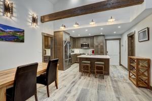 a kitchen with a wooden table and chairs at Fully Renovated 2 Bedroom in Arrowhead Village! condo in Edwards