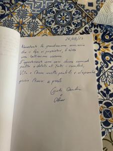 una carta escrita a mano en una mesa frente a una pared en Casa vacanza La Zagara en Mottola