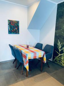Ferienwohnung Lindbruchblick في Niederkrüchten: غرفة طعام مع طاولة وكراسي زرقاء
