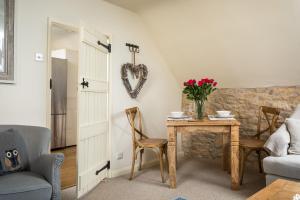 a living room with a table and a heart wall at The Loft: Unique, romantic, grade II listed, dog friendly in Stow on the Wold
