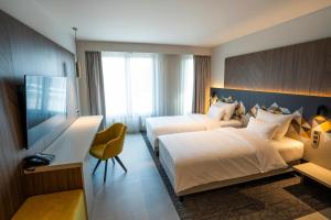 Ένα ή περισσότερα κρεβάτια σε δωμάτιο στο Austria Trend Hotel Ljubljana