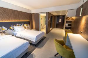 Ένα ή περισσότερα κρεβάτια σε δωμάτιο στο Austria Trend Hotel Ljubljana