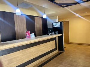 a bar in a room with a television and a counter at Ibeurohotel Guadalajara Expo in Guadalajara