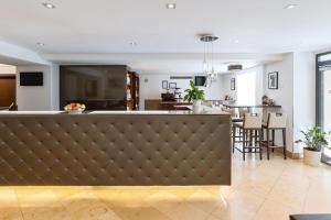 a living room with a bar and a dining room at Hotel Rathauspark Wien, a member of Radisson Individuals in Vienna