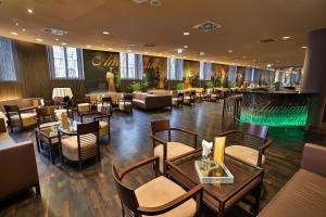 a restaurant with tables and chairs and a bar at Austria Trend Hotel Savoyen Vienna - 4 stars superior in Vienna