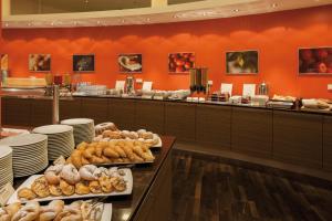 a buffet line with a lot of food on display at Austria Trend Hotel Savoyen Vienna - 4 stars superior in Vienna