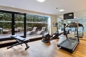 a gym with treadmills and ellipticals in a room at Austria Trend Hotel Congress Innsbruck in Innsbruck