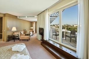 a hotel room with a bed and a large window at Austria Trend Hotel Savoyen Vienna - 4 stars superior in Vienna +71 photos