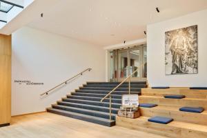 a building with stairs and a painting on the wall at Austria Trend Hotel Maximilian in Vienna