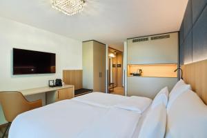Postel nebo postele na pokoji v ubytování Austria Trend Hotel Maximilian