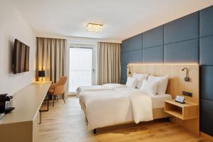 Postel nebo postele na pokoji v ubytování Austria Trend Hotel Maximilian