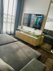 Zimmer mit 2 Betten und einem Flachbild-TV in der Unterkunft Apartamento novo linha verde - up life in Curitiba