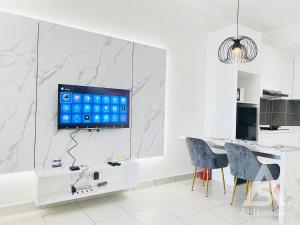 a kitchen with a tv on a white wall at Netizen Soho 2pax walking distance MRT Cheras Wi-Fi AsHome in Cheras