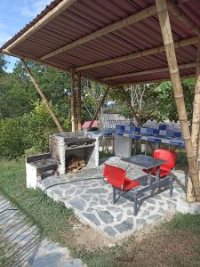 a patio with a table and chairs and a fireplace at El Guadual Casa Campestre in Ibagué