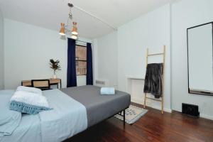 a bedroom with a large bed and a window at Cosy Studio Close to Times Square NYC in New York