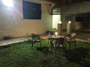 a patio with a table and chairs in the grass at Gaser resident in 6th Of October