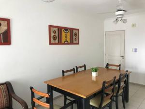 a dining room with a wooden table and chairs at Departamento Urquiza. in Santa Fe +14 photos