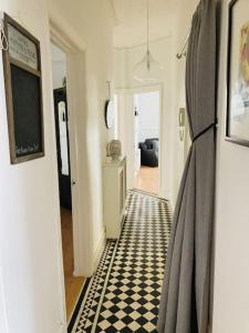 a hallway with a black and white checkered floor at No.18 - Ground Floor apartment close to the beach in Cromer