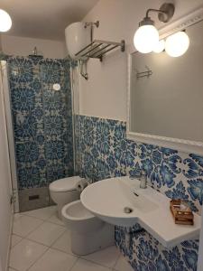 a bathroom with a sink and a toilet at Tre Re Appartamento Matima in Capri +8 photos