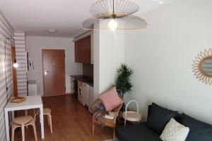 a living room with a couch and a table at Figueira Holidays in Buarcos