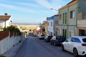 a street with cars parked on the side of the road at Figueira Holidays in Buarcos