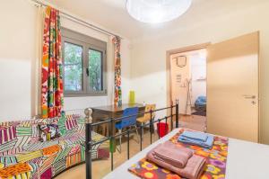 a living room with a bed and a table at Pop Art Home - Experience Local Vibes in Athens