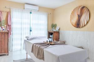 Ένα ή περισσότερα κρεβάτια σε δωμάτιο στο Mediterrane Hotel by Castelo Itaipava