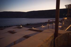 a view of the water from a house with lights at Monodendri Suites in Yerolimin