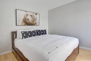 a bedroom with a bed with a picture of a dog at Cozy Chalet in the Mont Tremblant Ski Village in Mont-Tremblant