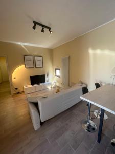 a bedroom with a large white bed and a table at Cecco Guest house in Pisa