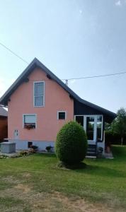 a pink house with a black roof at Holiday Home Vukovic in Saborsko