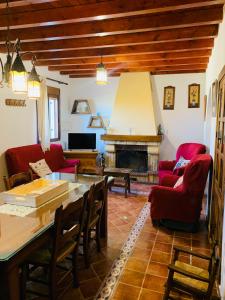 a living room with red furniture and a fireplace at La Venta in Purchena