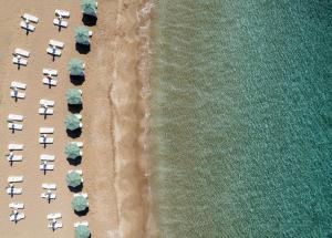 an overhead view of a beach with chairs and umbrellas at Blue Sea Karpasia Hotel in Rizokarpaso